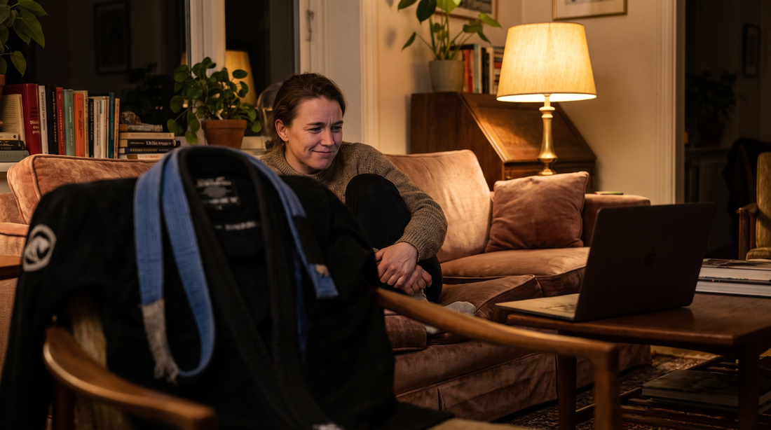 Shopping for BJJ gifts on a laptop with a gi hanging on a chair