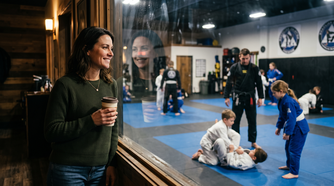 Mom watching her kids train jiu-jitsu through a gym window