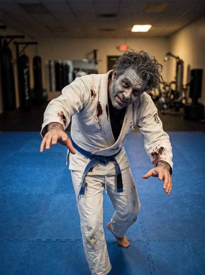 Zombie grappler BJJ Halloween costume in a torn, blood-stained gi