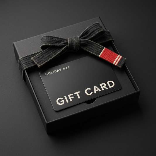 Holiday BJJ gift card in an open black gift box tied with a black BJJ belt